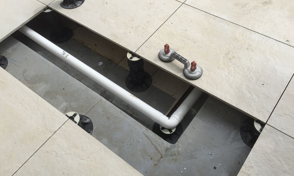 Service pipes running underneath tile deck